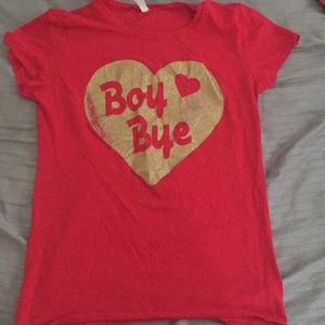 red shirt, that says “boy bye” in gold glitter.